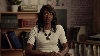 Movie still from “Slasher” (2016), created by Aaron Martin – A woman sitting in a chair wearing a necklace; Close Up shot, Over the shoulder angle