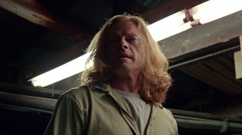 Movie still from “Slasher” (2016), created by Aaron Martin – A person with long blonde hair; Close Up shot, Low angle