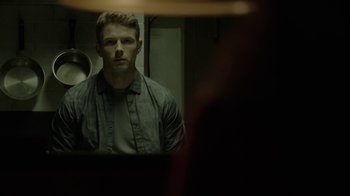 Movie still from “Slasher” (2016), created by Aaron Martin – A man standing in front of a bathroom mirror; Medium shot, Low angle