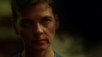 Movie still from “Slasher” (2016), created by Aaron Martin – A person's face in the dark; Close Up shot, Over the shoulder angle