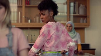 Movie still from “Slasher” (2016), created by Aaron Martin – A woman in a pink and white shirt is standing in front of another woman in a white hijab; Close Up shot, Over the shoulder angle