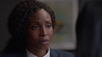 Movie still from “Slasher” (2016), created by Aaron Martin – A person wearing a suit and tie; Close Up shot, Over the shoulder angle