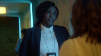 Movie still from “Slasher” (2016), created by Aaron Martin – A woman wearing a white shirt and a black jacket; Close Up shot, Over the shoulder angle