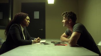 Movie still from “Slasher” (2016), created by Aaron Martin – A man and a woman sitting at a table talking; Medium shot, Over the shoulder angle