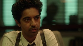 Movie still from “Slasher” (2016), created by Aaron Martin – A person wearing a shirt and tie; Close Up shot, Over the shoulder angle