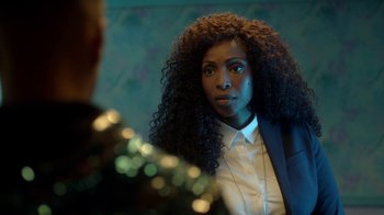 Movie still from “Slasher” (2016), created by Aaron Martin – A woman in a white shirt and a black suit jacket; Close Up shot, Over the shoulder angle