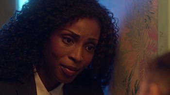 Movie still from “Slasher” (2016), created by Aaron Martin – A person with curly hair; Close Up shot, Over the shoulder angle