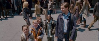 Movie still from “Spider-Man 3” (2007), directed by Sam Raimi – A group of young people standing next to each other on a sidewalk; Medium shot, Over the shoulder angle