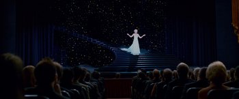 Movie still from “Spider-Man 3” (2007), directed by Sam Raimi – A woman in a white dress standing on a set of stairs; Wide shot, Low angle