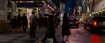 Movie still from “Spider-Man 3” (2007), directed by Sam Raimi – A group of people walking down a street at night; Wide shot, Over the shoulder angle