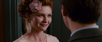 Movie still from “Spider-Man 3” (2007), directed by Sam Raimi – A woman with a flower in her hair looking at a man in a suit; Close Up shot, Over the shoulder angle