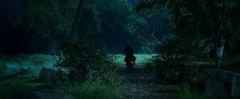 Movie still from “Spider-Man 3” (2007), directed by Sam Raimi – A man riding a motorcycle down a dirt road; Wide shot, High angle