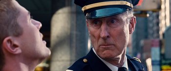 Movie still from “Spider-Man 3” (2007), directed by Sam Raimi – An old man in a uniform is looking at the camera; Close Up shot, Low angle