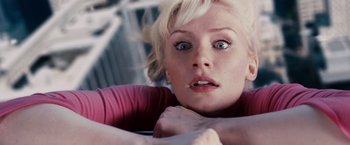Movie still from “Spider-Man 3” (2007), directed by Sam Raimi – A woman with blonde hair and blue eyes looking at the camera; Close Up shot, Overhead angle