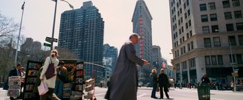 Movie still from “Spider-Man 3” (2007), directed by Sam Raimi – A man in a long coat is walking down the street; Extreme Wide shot, Low angle