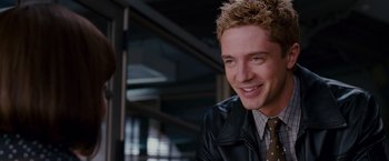 Movie still from “Spider-Man 3” (2007), directed by Sam Raimi – A man smiling at the camera; Close Up shot, Over the shoulder angle