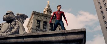 Movie still from “Spider-Man 3” (2007), directed by Sam Raimi – A man dressed as spider - man standing on a ledge; Wide shot, Low angle