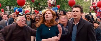 Movie still from “Spider-Man 3” (2007), directed by Sam Raimi – A crowd of people walking down a street with balloons in the background; Medium shot, High angle