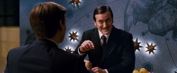 Movie still from “Spider-Man 3” (2007), directed by Sam Raimi – A man in a black suit and a man in a white shirt and tie; Medium shot, Over the shoulder angle