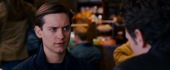 Movie still from “Spider-Man 3” (2007), directed by Sam Raimi – A young man is looking into the distance; Close Up shot, Over the shoulder angle
