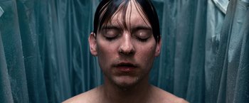 Movie still from “Spider-Man 3” (2007), directed by Sam Raimi – A man with his eyes closed with water pouring on his face; Close Up shot, Overhead angle