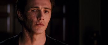 Movie still from “Spider-Man 3” (2007), directed by Sam Raimi – A man's face in the dark; Close Up shot, Over the shoulder angle