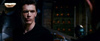 Movie still from “Spider-Man 3” (2007), directed by Sam Raimi – A man in a black shirt is looking at the camera; Close Up shot, Low angle