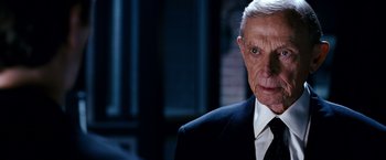 Movie still from “Spider-Man 3” (2007), directed by Sam Raimi – An older man wearing a suit and tie; Close Up shot, Over the shoulder angle
