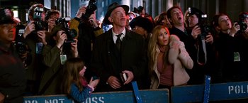 Movie still from “Spider-Man 3” (2007), directed by Sam Raimi – A crowd of people gathered around a man wearing a hat; Medium shot, Over the shoulder angle