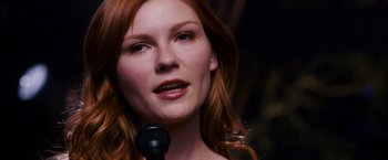 Movie still from “Spider-Man 3” (2007), directed by Sam Raimi – A person holding a microphone; Close Up shot, Low angle