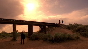 Movie still from “Breaking Bad” (2008), created by Vince Gilligan – A group of people standing next to a bridge; Extreme Wide shot, Low angle