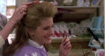 Movie still from “Steel Magnolias” (1989), directed by Herbert Ross – A woman getting her hair cut at a hair salon; Close Up shot, Over the shoulder angle