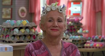 Movie still from “Steel Magnolias” (1989), directed by Herbert Ross – An older woman wearing a hair curlers in a store; Close Up shot, Low angle