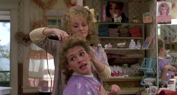 Movie still from “Steel Magnolias” (1989), directed by Herbert Ross – Two women blow drying each other's hair in a hair salon; Medium shot, Over the shoulder angle