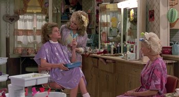 Movie still from “Steel Magnolias” (1989), directed by Herbert Ross – A woman in a dressing room getting her hair done; Medium shot, Over the shoulder angle