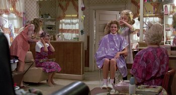 Movie still from “Steel Magnolias” (1989), directed by Herbert Ross – A girl getting her hair cut at a salon; Medium shot, Over the shoulder angle