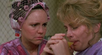 Movie still from “Steel Magnolias” (1989), directed by Herbert Ross – Two women holding hands and looking at each other; Close Up shot, Over the shoulder angle