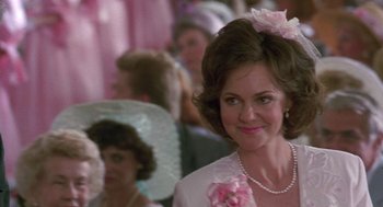 Movie still from “Steel Magnolias” (1989), directed by Herbert Ross – A person wearing a dress and a hat; Close Up shot, Over the shoulder angle