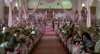 Movie still from “Steel Magnolias” (1989), directed by Herbert Ross – A group of people sitting in a room with pink decorations; Wide shot, High angle