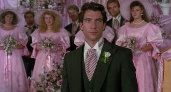 Movie still from “Steel Magnolias” (1989), directed by Herbert Ross – A man standing in front of a group of people; Close Up shot, Over the shoulder angle