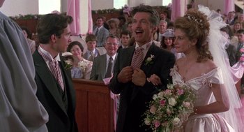 Movie still from “Steel Magnolias” (1989), directed by Herbert Ross – A group of people standing around a room with flowers; Medium shot, Over the shoulder angle