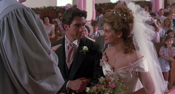 Movie still from “Steel Magnolias” (1989), directed by Herbert Ross – A man and a woman in wedding attire standing next to each other in front of a crowd; Close Up shot, Over the shoulder angle