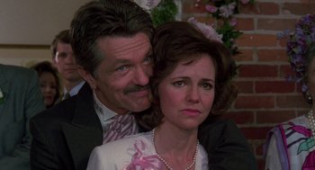 Movie still from “Steel Magnolias” (1989), directed by Herbert Ross – A man and a woman posing for a picture; Close Up shot, Over the shoulder angle