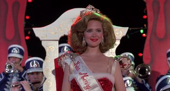 Movie still from “Steel Magnolias” (1989), directed by Herbert Ross – A woman is wearing a crown and a red dress; Close Up shot, Low angle