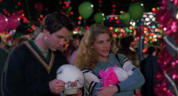 Movie still from “Steel Magnolias” (1989), directed by Herbert Ross – A man and a woman are holding their babies; Medium shot, Over the shoulder angle