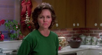 Movie still from “Steel Magnolias” (1989), directed by Herbert Ross – A person wearing a green shirt in a room; Close Up shot, Over the shoulder angle