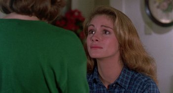 Movie still from “Steel Magnolias” (1989), directed by Herbert Ross – A woman looking at another woman in front of a mirror; Close Up shot, Over the shoulder angle