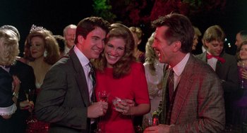 Movie still from “Steel Magnolias” (1989), directed by Herbert Ross – A group of people that are standing around a room together; Medium shot, Over the shoulder angle