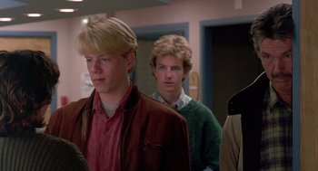 Movie still from “Steel Magnolias” (1989), directed by Herbert Ross – Two young men are standing in a hallway; Medium shot, Low angle