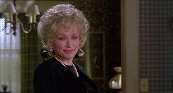 Movie still from “Steel Magnolias” (1989), directed by Herbert Ross – An older woman in a black dress with a pearl necklace; Close Up shot, Over the shoulder angle